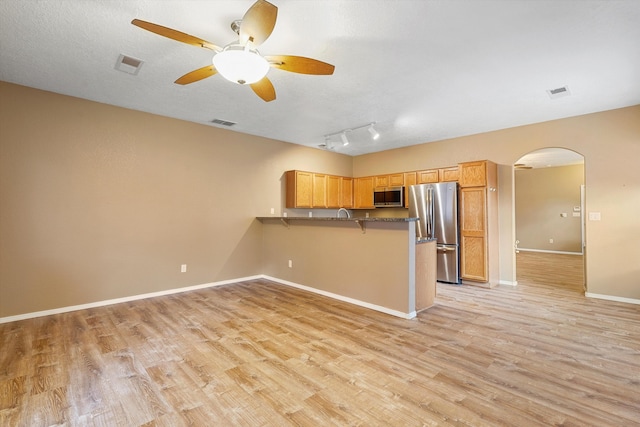 5443 Reserve Ct NE, Rio Rancho, NM 87144 - kitchen featuring stainless steel appliances, arched walkways, a peninsula, light wood-style flooring, and ceiling fan