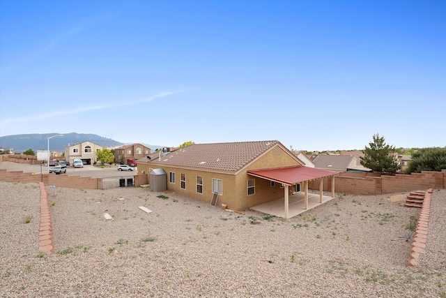 5443 Reserve Ct NE, Rio Rancho, NM 87144 - rear view of property with a patio area, stucco siding, a fenced backyard, and a mountain view