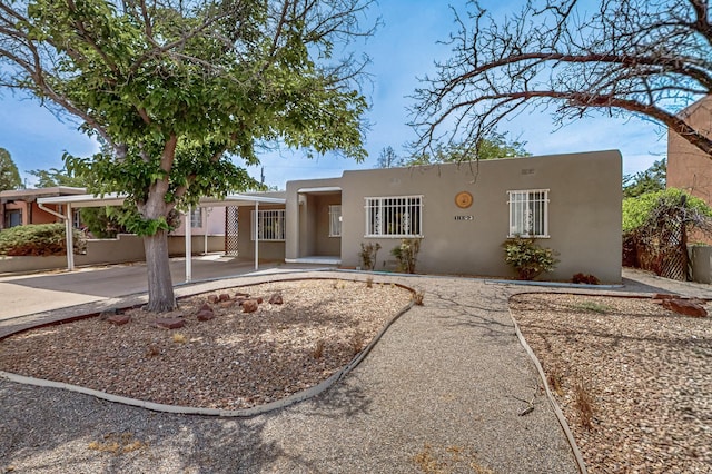1103 Madison St SE, Albuquerque, NM 87108 - view of front of house featuring stucco siding and a carport