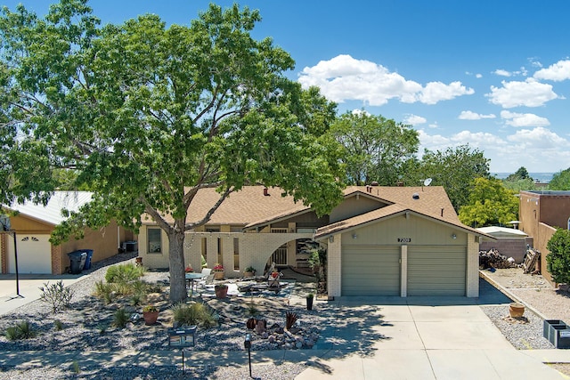 7209 Yorktown Ave NE, Albuquerque, NM 87109 - view of front facade with concrete driveway, an attached garage, and brick siding