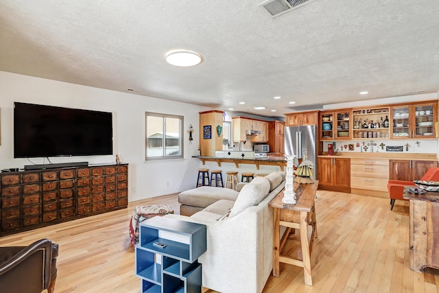 7209 Yorktown Ave NE, Albuquerque, NM 87109 - living area with light wood finished floors, a textured ceiling, and recessed lighting