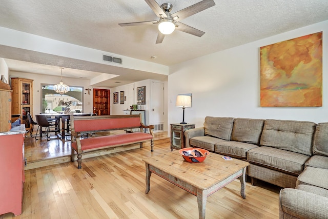 7209 Yorktown Ave NE, Albuquerque, NM 87109 - living area featuring ceiling fan, light wood finished floors, a chandelier, and a textured ceiling