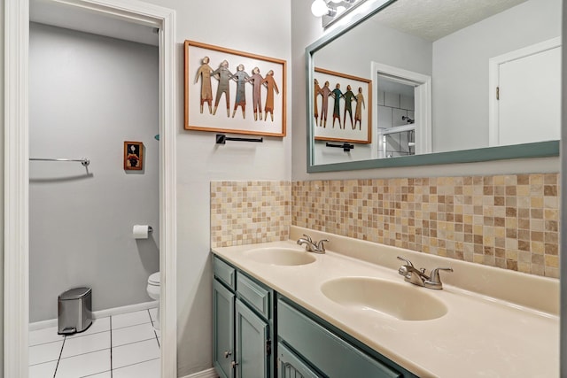 7209 Yorktown Ave NE, Albuquerque, NM 87109 - bathroom with double vanity, tile patterned floors, and backsplash