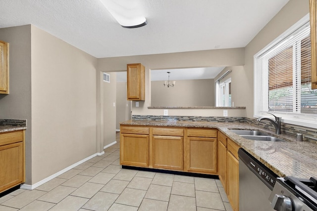 6312 Zimmerman Ave NE, Albuquerque, NM 87110 - kitchen with stainless steel dishwasher, light tile patterned floors, light stone counters, and a chandelier