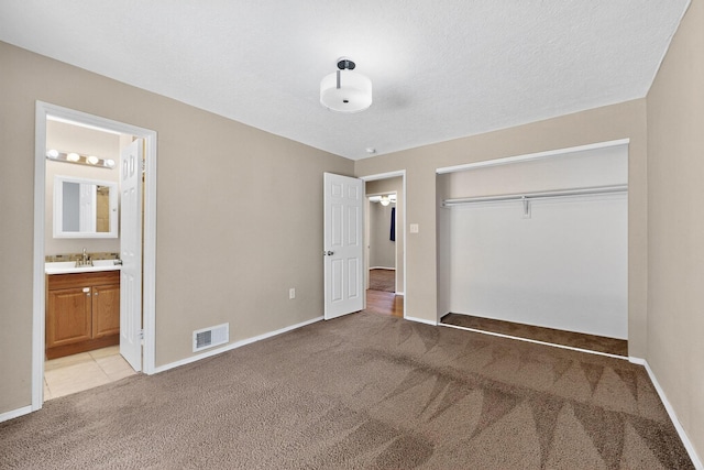 6312 Zimmerman Ave NE, Albuquerque, NM 87110 - unfurnished bedroom featuring light carpet, a closet, and ensuite bath