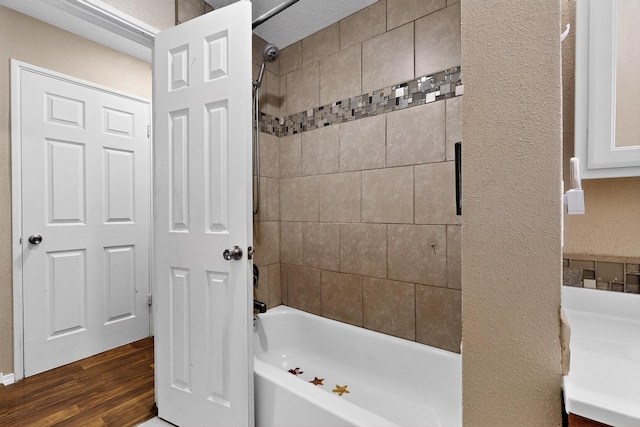 6312 Zimmerman Ave NE, Albuquerque, NM 87110 - full bath with a textured wall, shower / tub combination, and wood finished floors