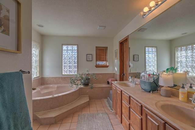 400 Paseo Del Bosque NW, Albuquerque, NM 87114 - full bathroom with a garden tub, tile patterned floors, double vanity, and a textured ceiling