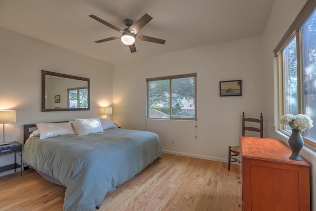 9404 Bear Mountain Trl NE, Albuquerque, NM 87113 - bedroom featuring multiple windows, light wood finished floors, and ceiling fan
