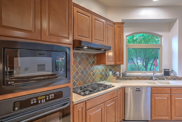 9404 Bear Mountain Trl NE, Albuquerque, NM 87113 - kitchen featuring black appliances, under cabinet range hood, decorative backsplash, and light countertops