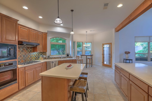 9404 Bear Mountain Trl NE, Albuquerque, NM 87113 - kitchen featuring black appliances, backsplash, under cabinet range hood, healthy amount of natural light, and recessed lighting