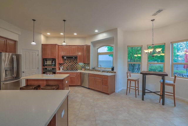 9404 Bear Mountain Trl NE, Albuquerque, NM 87113 - kitchen with black appliances, decorative backsplash, light countertops, light tile patterned flooring, and recessed lighting