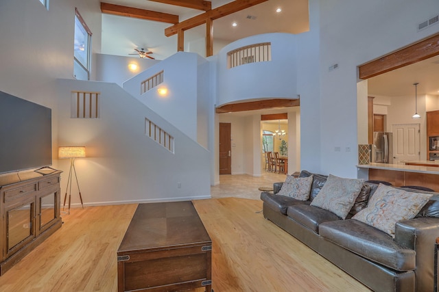 9404 Bear Mountain Trl NE, Albuquerque, NM 87113 - living room featuring a ceiling fan, beam ceiling, a high ceiling, recessed lighting, and a chandelier