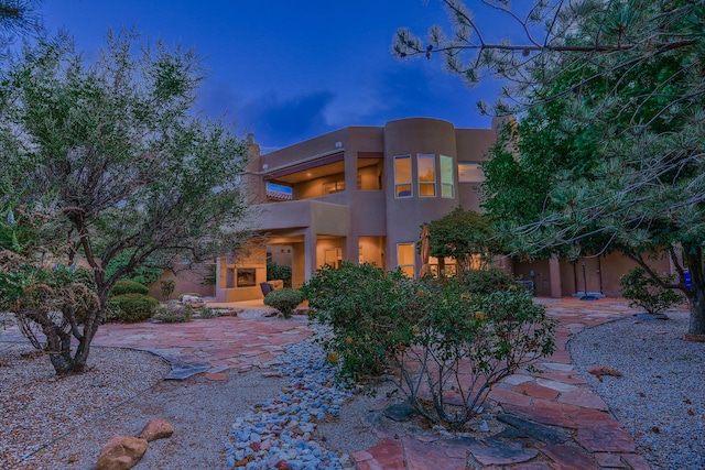 9404 Bear Mountain Trl NE, Albuquerque, NM 87113 - rear view of property with stucco siding, a patio area, and a balcony