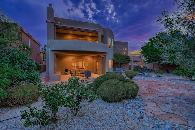 9404 Bear Mountain Trl NE, Albuquerque, NM 87113 - back of property with a balcony, a patio, a chimney, and outdoor lounge area
