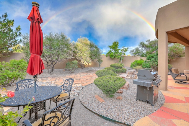 9404 Bear Mountain Trl NE, Albuquerque, NM 87113 - fenced backyard featuring grilling area, a patio, and outdoor dining space