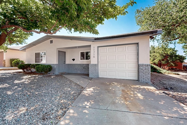 11716 Copper Pl NE, Albuquerque, NM 87123 - single story home featuring brick siding, stucco siding, concrete driveway, and an attached garage
