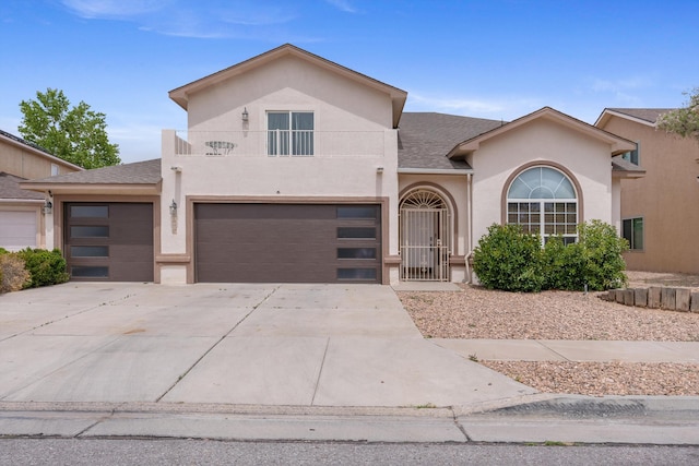 10208 Luz Del Dia Dr NW, Albuquerque, NM 87114 - view of front of property featuring a balcony, stucco siding, driveway, a garage, and roof with shingles