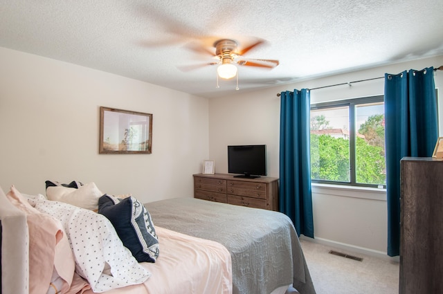 6820 Los Trechos Ct NE, Albuquerque, NM 87109 - bedroom featuring light carpet, a textured ceiling, and ceiling fan