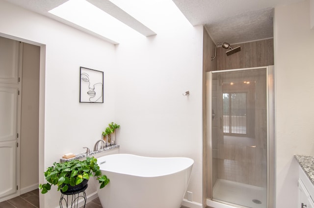 6820 Los Trechos Ct NE, Albuquerque, NM 87109 - full bath with a stall shower, vanity, a freestanding tub, and a textured ceiling