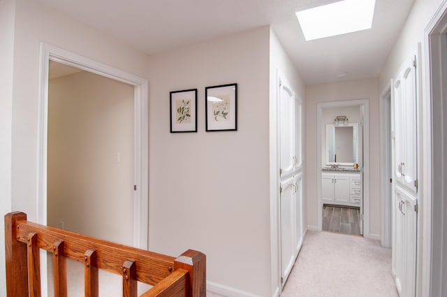 6820 Los Trechos Ct NE, Albuquerque, NM 87109 - hallway with a skylight and light carpet