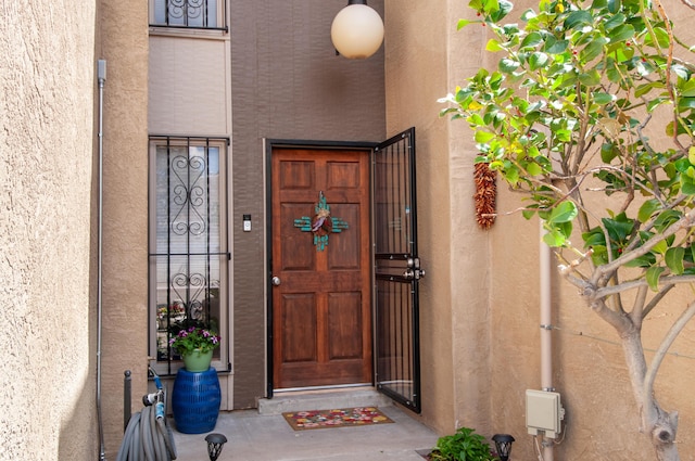 6820 Los Trechos Ct NE, Albuquerque, NM 87109 - doorway to property with stucco siding