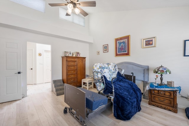 596 Eastlake Dr SE, Rio Rancho, NM 87124 - bedroom with a towering ceiling, wood finished floors, and a ceiling fan