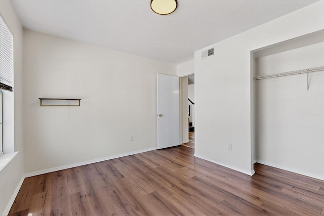 4429 Cattleya Rd NW, Albuquerque, NM 87120 - unfurnished bedroom featuring wood finished floors and a closet
