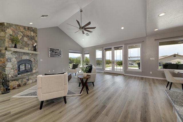 42 Los Pecos Loop, Tijeras, NM 87059 - living room featuring ceiling fan, wood finished floors, high vaulted ceiling, a fireplace, and recessed lighting