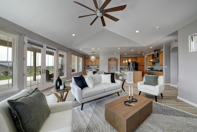 42 Los Pecos Loop, Tijeras, NM 87059 - living room featuring ceiling fan, french doors, lofted ceiling, light wood-style flooring, and recessed lighting