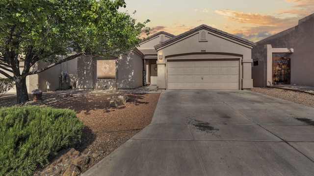 3915 Tundra Swan Ct NW, Albuquerque, NM 87120 - view of front of house with driveway, stucco siding, and a garage