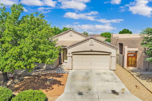 3915 Tundra Swan Ct NW, Albuquerque, NM 87120 - view of front of house with concrete driveway, an attached garage, and stucco siding