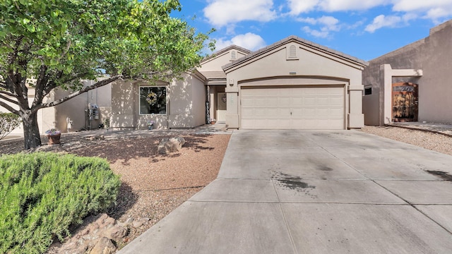 3915 Tundra Swan Ct NW, Albuquerque, NM 87120 - view of front of property featuring concrete driveway, an attached garage, stucco siding, and a tile roof