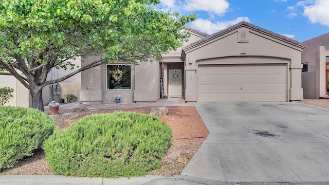3915 Tundra Swan Ct NW, Albuquerque, NM 87120 - view of front of property featuring concrete driveway, stucco siding, a garage, and a tiled roof