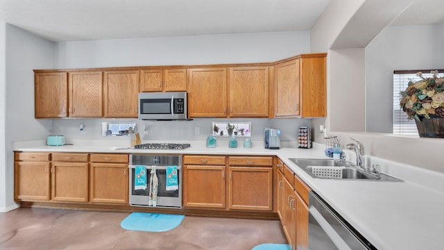 3915 Tundra Swan Ct NW, Albuquerque, NM 87120 - kitchen featuring appliances with stainless steel finishes, light countertops, concrete floors, and brown cabinets