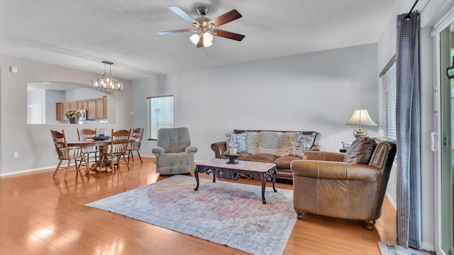 3915 Tundra Swan Ct NW, Albuquerque, NM 87120 - living room with ceiling fan, light wood finished floors, arched walkways, and a textured ceiling