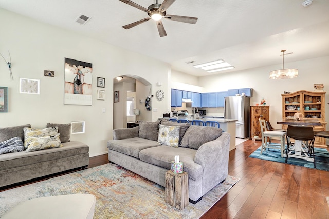 640 Renaissance Loop SE, Rio Rancho, NM 87124 - living area featuring arched walkways, a ceiling fan, and dark wood-style floors
