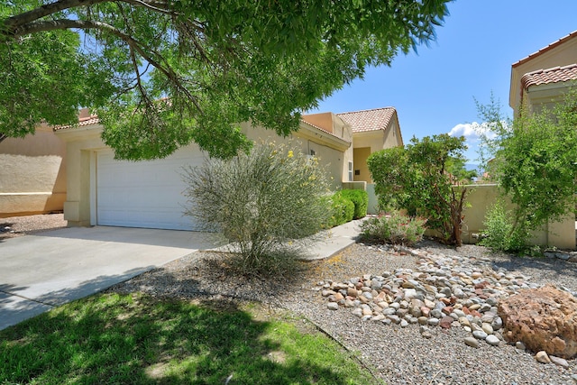 640 Renaissance Loop SE, Rio Rancho, NM 87124 - view of front facade featuring a tile roof, stucco siding, and concrete driveway