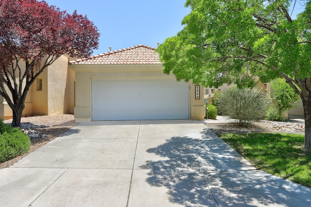 640 Renaissance Loop SE, Rio Rancho, NM 87124 - view of front of house featuring stucco siding, a tile roof, concrete driveway, and a garage