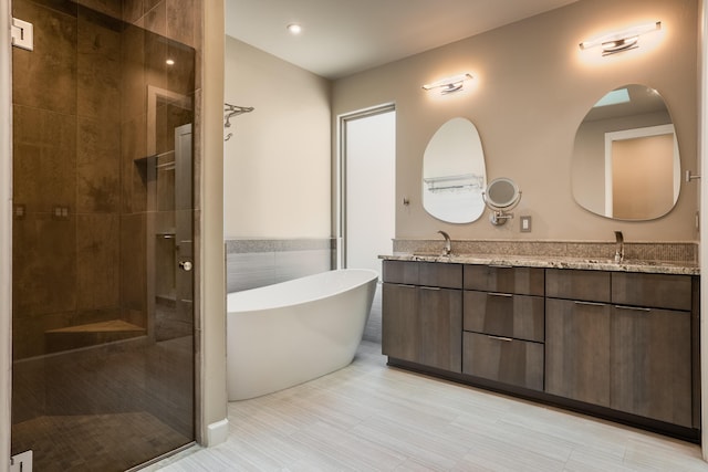 5402 Grays Peak Trl NE, Rio Rancho, NM 87144 - full bathroom with double vanity, a freestanding tub, and a stall shower