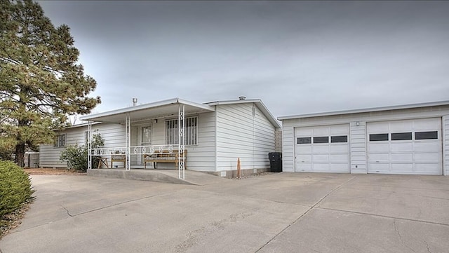 6836 Ina Dr NE, Albuquerque, NM 87109 - view of front of property featuring a garage, a porch, and concrete driveway