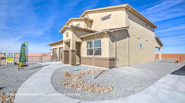 1652 Maggie Ct NE, Rio Rancho, NM 87144 - view of property exterior featuring stucco siding, a gate, and a patio