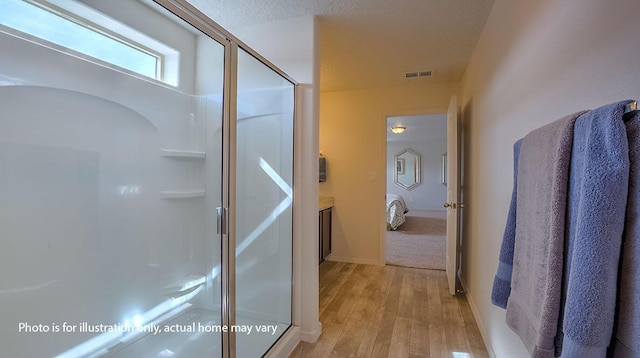 1652 Maggie Ct NE, Rio Rancho, NM 87144 - bathroom featuring a stall shower, wood finished floors, and ensuite bathroom