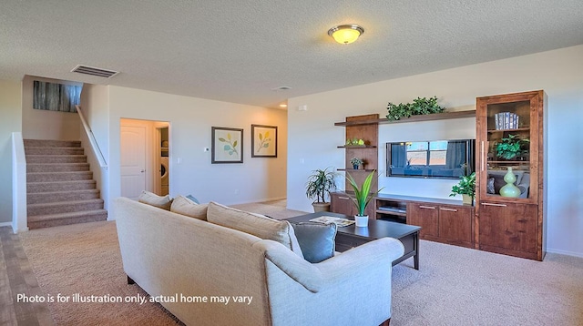 1652 Maggie Ct NE, Rio Rancho, NM 87144 - living area featuring light colored carpet, stairs, and a textured ceiling