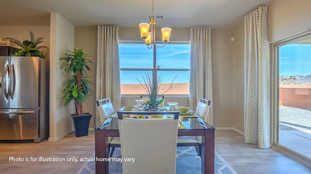1652 Maggie Ct NE, Rio Rancho, NM 87144 - dining room with light wood finished floors and a chandelier