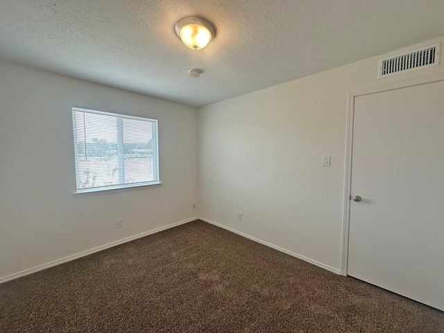 5612 Territorial Rd NW, Albuquerque, NM 87120 - empty room with dark colored carpet, a smoke detector, and a textured ceiling