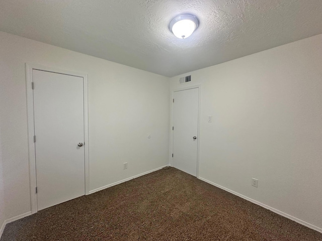 5612 Territorial Rd NW, Albuquerque, NM 87120 - empty room with dark colored carpet and a textured ceiling