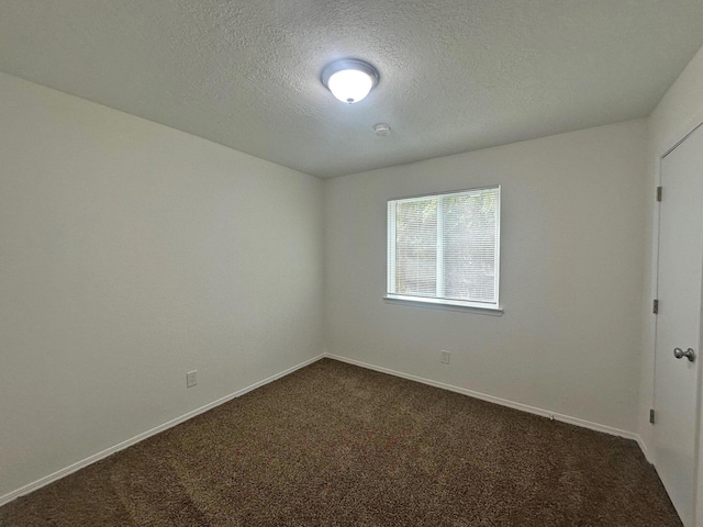 5612 Territorial Rd NW, Albuquerque, NM 87120 - spare room with dark carpet, a textured ceiling, and a smoke detector