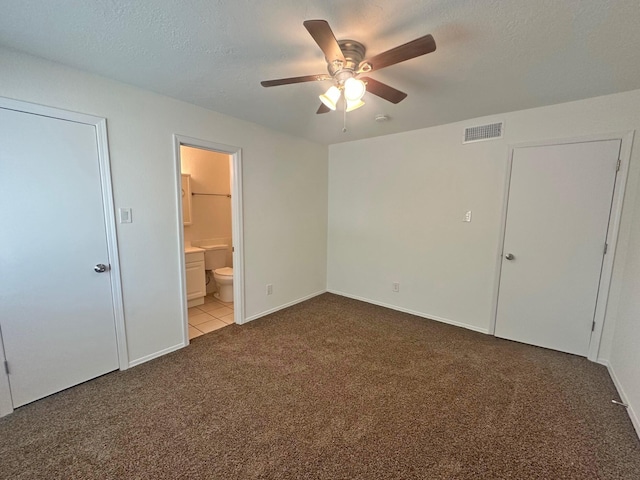 5612 Territorial Rd NW, Albuquerque, NM 87120 - unfurnished bedroom featuring carpet floors, ensuite bathroom, a ceiling fan, and a textured ceiling