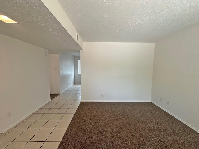 5612 Territorial Rd NW, Albuquerque, NM 87120 - empty room with a textured ceiling and light tile patterned floors