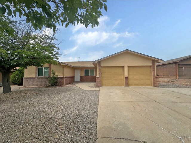 5612 Territorial Rd NW, Albuquerque, NM 87120 - single story home with an attached garage, brick siding, driveway, and stucco siding